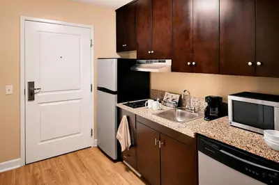 a kitchen with a sink and a white refrigerator at TownePlace Suites by Marriott Harrisburg Hershey in Harrisburg