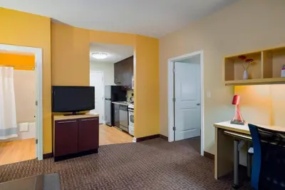 a living room with a television and a kitchen at TownePlace Suites by Marriott Harrisburg Hershey in Harrisburg
