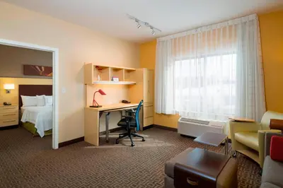 a hotel room with a bed and a desk in a room at TownePlace Suites by Marriott Harrisburg Hershey in Harrisburg