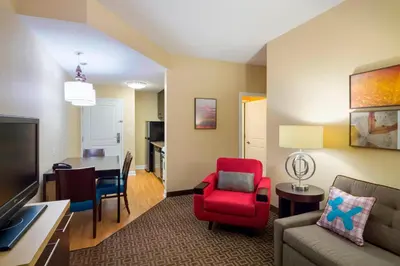 a living room with a couch and a dining room at TownePlace Suites by Marriott Harrisburg Hershey in Harrisburg
