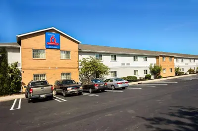 a hotel with cars parked in a parking lot at Studio 6-East Brunswick, NJ - NYC Area in East Brunswick