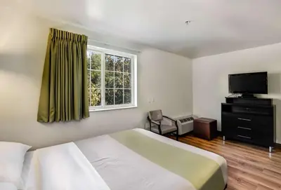 a bedroom with a bed and a television and a window at Studio 6-East Brunswick, NJ - NYC Area in East Brunswick