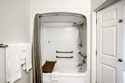 a bathroom with a shower and a bathtub with towels at Studio 6-East Brunswick, NJ - NYC Area in East Brunswick