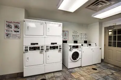 a laundry room with white appliances and a washer and dryer at Studio 6-East Brunswick, NJ - NYC Area in East Brunswick