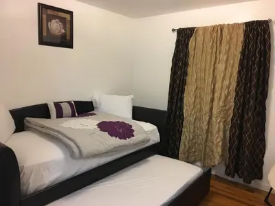 a bedroom with a bed and a window at Mojoy Homesuites At Runyon in Newark