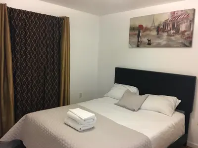 a bedroom with a bed with a box on it at Mojoy Homesuites At Runyon in Newark