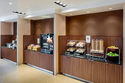 a buffet line with food on display in a hotel room at Fairfield Inn & Suites by Marriott North Bergen in North Bergen