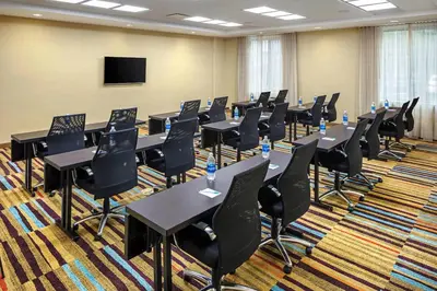 a conference room with tables and chairs and a tv at Fairfield Inn & Suites by Marriott North Bergen in North Bergen