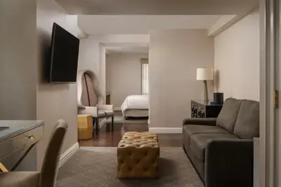 a living room with a couch and a bedroom at The Manhattan Club in New York