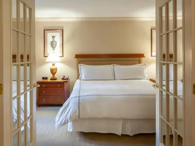 a bedroom with a large white bed and a nightstand at The Manhattan Club in New York