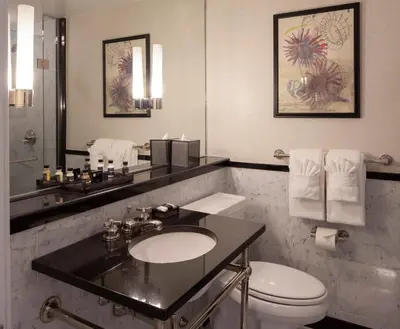 a bathroom with a sink and a toilet and a mirror at The Manhattan Club in New York
