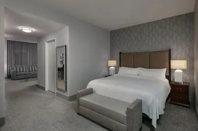 a bedroom with a large white bed and a chair at Philadelphia Marriott Downtown in Philadelphia