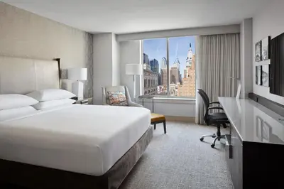 a hotel room with a bed and a desk and a window at Philadelphia Marriott Downtown in Philadelphia