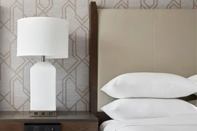 a lamp on a table next to a bed with pillows at Philadelphia Marriott Downtown in Philadelphia