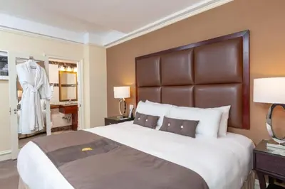 a bedroom with a large bed with a large headboard at Fitzpatrick Manhattan in New York