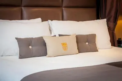 a group of pillows on a bed in a room at Fitzpatrick Manhattan in New York