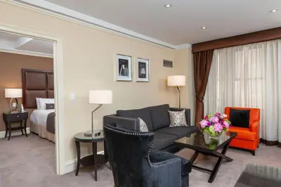 a living room with a couch and a room with a bed at Fitzpatrick Manhattan in New York