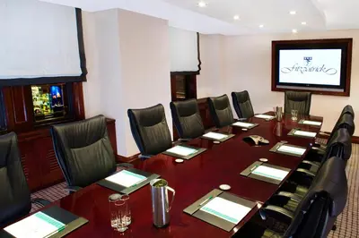 a conference room with a long table and chairs at Fitzpatrick Manhattan in New York