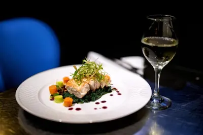 a plate of food next to a glass of wine at Fitzpatrick Manhattan in New York