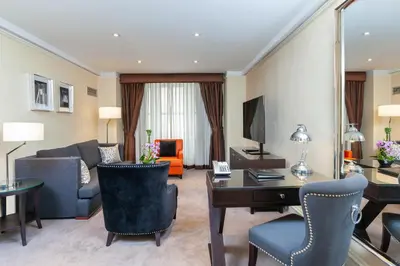 a living room with a couch and a table with chairs at Fitzpatrick Manhattan in New York