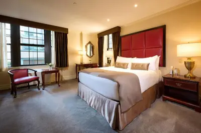 a bedroom with a large bed and a red headboard at Fitzpatrick Grand Central in New York