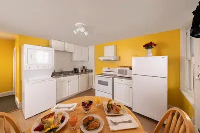 a kitchen with a table with plates of food on it at Carlisle House Bed and Breakfast in Carlisle