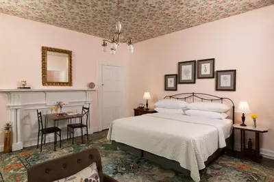 a bedroom with a bed and a table and a chair at Carlisle House Bed and Breakfast in Carlisle
