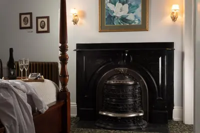 a black fireplace in a bedroom with a bed at Carlisle House Bed and Breakfast in Carlisle