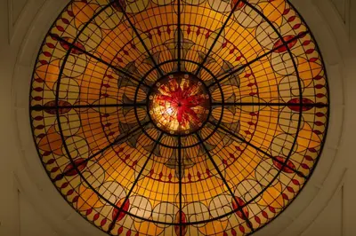 a large stained glass window on the ceiling of a building at New York Marriott Downtown in New York