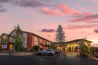 a building with a car parked in a parking lot at Best Western Monticello in Monticello