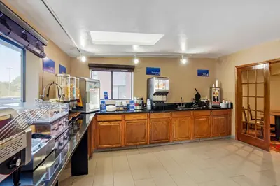 a large kitchen with wooden cabinets and appliances at Best Western Monticello in Monticello