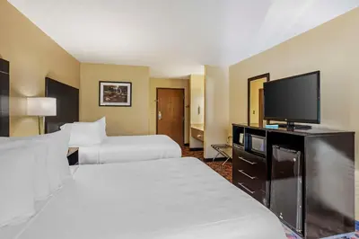 a hotel room with two beds and a flat screen tv at Best Western Monticello in Monticello