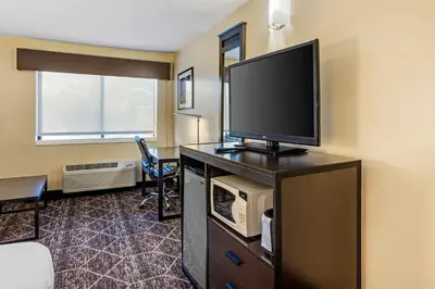 a hotel room with a flat screen tv on a desk at Best Western Monticello in Monticello