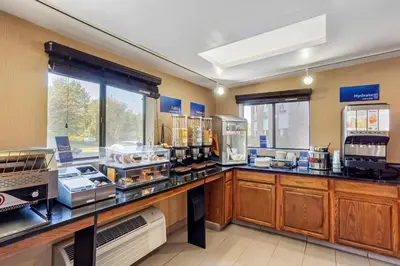 a large kitchen with a counter with many appliances at Best Western Monticello in Monticello