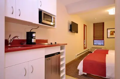 a kitchen with a sink and a bed in a room at Hotel Five44 in New York