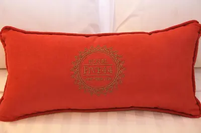 a red pillow sitting on top of a bed at Hotel Five44 in New York