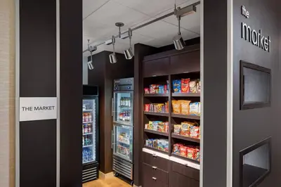 a store aisle with a refrigerator and shelves of food at Courtyard by Marriott Wayne Fairfield in Wayne