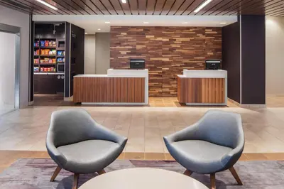 a lobby with two chairs and a counter at Courtyard by Marriott Wayne Fairfield in Wayne