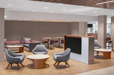 a waiting room with chairs and a flat screen tv at Courtyard by Marriott Wayne Fairfield in Wayne