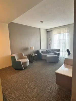 a living room with a couch and a chair at Courtyard by Marriott Deptford in Almonesson