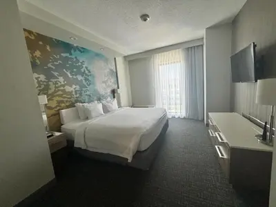 a hotel room with a large bed and a window at Courtyard by Marriott Deptford in Almonesson