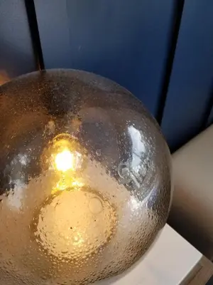 a metal vase sitting on top of a table at Redford Hotel in New York