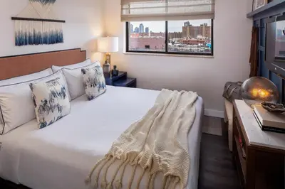 a bedroom with a bed with a view of a city at Redford Hotel in New York