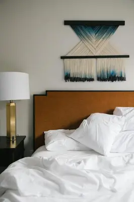 a bed with white sheets and a wooden headboard at Redford Hotel in New York
