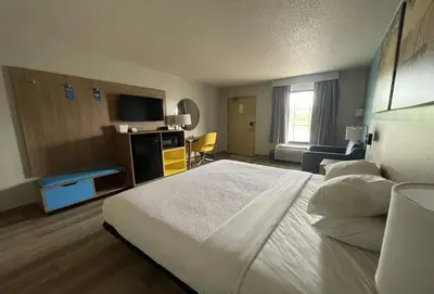 a hotel room with a bed and a television at Days Inn & Suites by Wyndham York in York