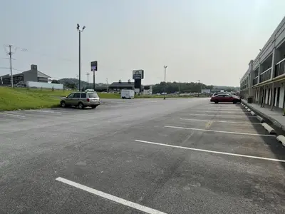 an empty parking lot with two cars parked in it at Days Inn & Suites by Wyndham York in York
