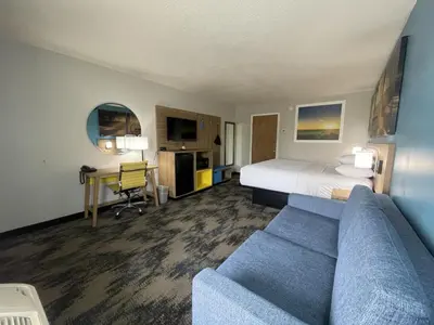 a hotel room with a bed and a couch at Days Inn & Suites by Wyndham York in York