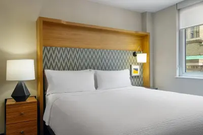 a bedroom with a large white bed and a window at Holiday Inn New York City - Wall Street by IHG in New York