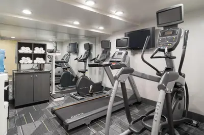 a gym with several tread machines and a treadmill at Holiday Inn New York City - Wall Street by IHG in New York