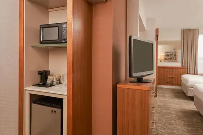 a hotel room with a television and a bed at SpringHill Suites by Marriott Philadelphia Airport / Ridley Park in Ridley Park